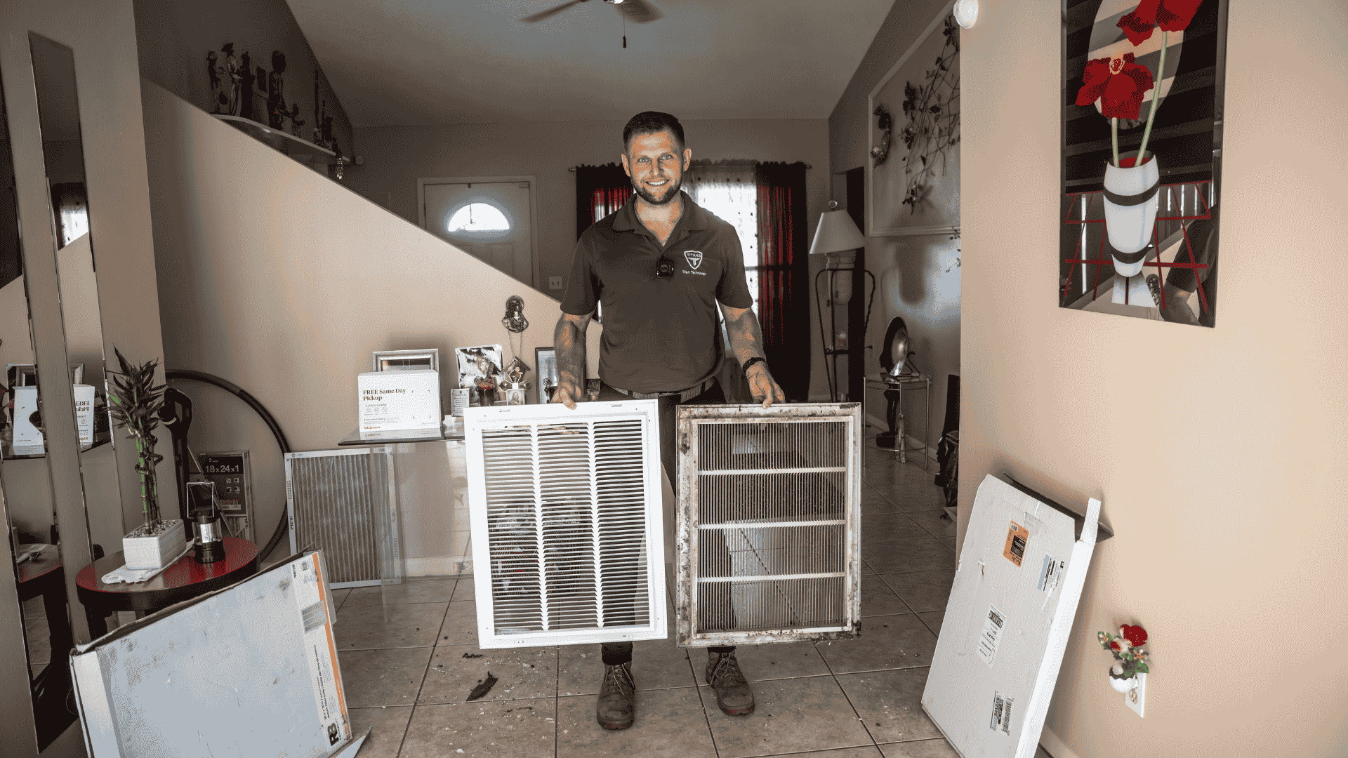 Side-by-side comparison of a dirty and a clean air filter held by an Air Titans professional inside a home.